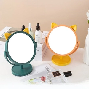 Rotating desktop makeup mirror with cute cat ears and round base in green and orange