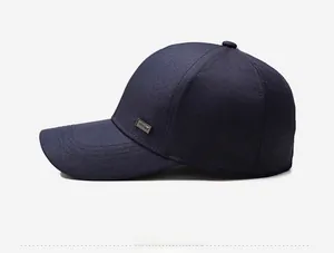 Close-up of navy blue baseball cap showing twill fabric and metal side plate detail