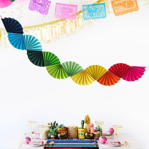 Close-up of vibrant multi-colored pleated paper fans for festive party decoration