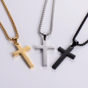 Three minimalist cross necklaces in gold, silver, and black stainless steel box chains