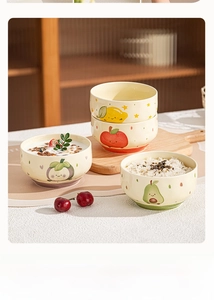 Detailed view of four ceramic bowls featuring cute lemon, apple, and avocado patterns