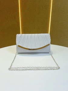 Detail view of the elegant pleated satin fabric and golden metallic trim on the clutch