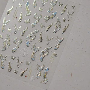 Detail of 3D embossed nail art stickers with gold phoenix and blue butterfly patterns
