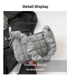 Detail view of silver quilted handbag featuring unique scrunchie handle and glitter texture