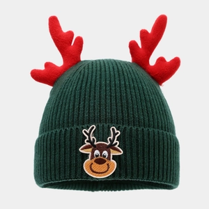 Detailed knit texture and reindeer embroidery on dark green Christmas beanie hat