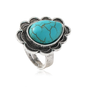 Vintage teardrop turquoise ring with antique silver floral setting and open band design