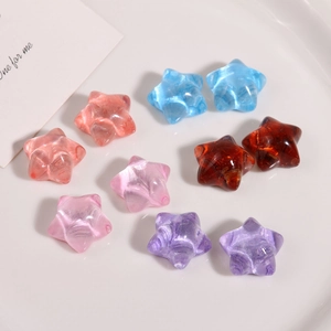 Detail of colorful translucent star resin charms with internal marble texture for DIY jewelry