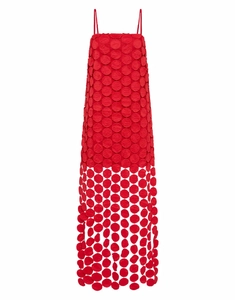 Detailed view of red hollow-out polka dot fabric and fringe hem on stylish midi dress