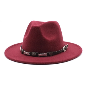 Detail of burgundy wool fedora hat featuring star studs and silver western metal buckle