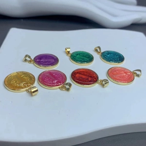 Set of seven colorful enamel Saint Benedict medal pendants with golden metal frames