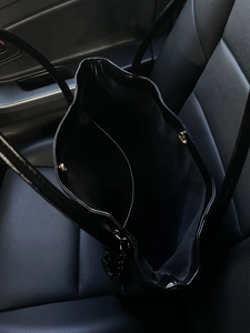 Large black glossy tote bag with spacious interior and magnetic closure for daily use