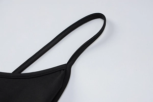 Close-up of sleek black elastic straps on a minimalist high-waist slim fit maxi dress