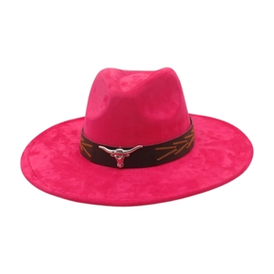 Detail of hot pink western cowboy hat featuring black band with silver bull head ornament
