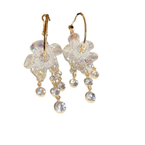 Elegant gold flower earrings with iridescent crystal petals and long tassel fringe