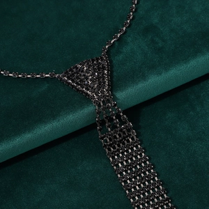 Detailed macro view of black rhinestone necktie necklace with intricate grid setting