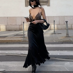 Street style view of a slim black lace patchwork maxi dress with mesh hem and straps