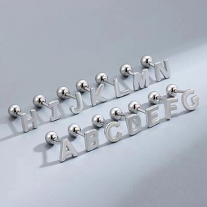 Detailed macro shot of silver stainless steel letter stud earrings from A to N
