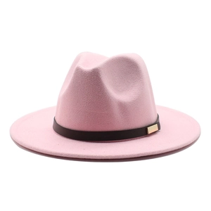 Close-up of pink wool fedora hat featuring a brown leather band and gold metal buckle