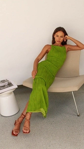 Detail of green bodycon dress featuring halter neck and ruched texture fabric