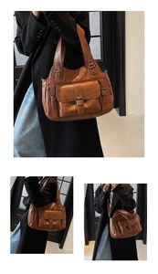 Brown PU leather tote bag showing front pocket detail and adjustable crossbody strap