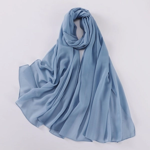 Close-up of blue pearl chiffon shawl with silver rhinestones and 100% polyester label