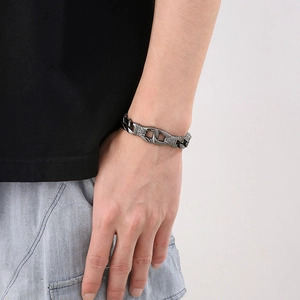 Macro view of men's vintage stainless steel bracelet with engraved floral patterns