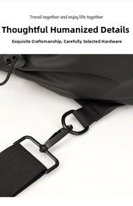 Detail of the black matte fabric, nylon strap, and metal hook on this large sling bag