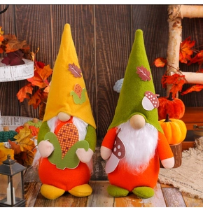 Detail of two autumn-themed gnome plush toys with corn and mushroom decorations