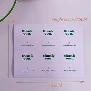 Detail of minimalist rectangular Thank You stickers in light purple for gift packaging
