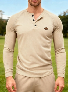 Detail of men's waffle knit henley shirt with button neckline and textured fabric
