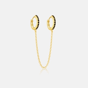 Detail view of gold double hoop earrings with black zircon stones and a chain link
