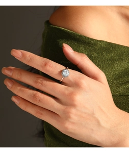 Detail of s925 silver hexagonal halo ring with sparkling main stone on finger
