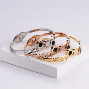 Three-piece rose gold, gold and silver Roman numeral bangle set with shell inlay