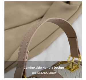 Detail view of the white woven texture and leather handle with golden metal buckle