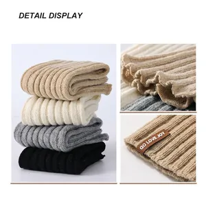 Winter wool knitted leg warmers in various colors featuring ribbed texture and leather tag