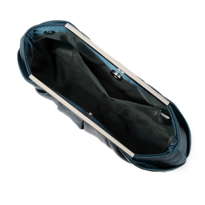Interior view of navy pleated satin evening bag with silver metal frame and side pocket