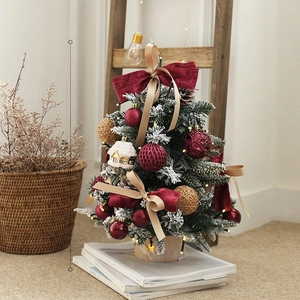 Snow-flocked 45cm mini Christmas tree with red bows and warm LED lights on wood base
