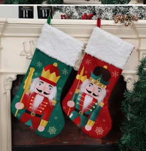 Detail of Christmas stockings with nutcracker soldier patterns hanging on a fireplace