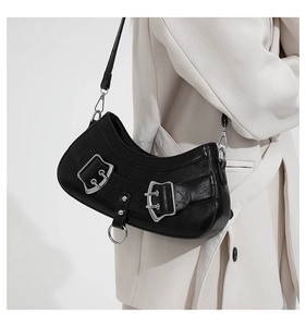 Detail view of black vintage shoulder bag with silver double metal buckles and rings