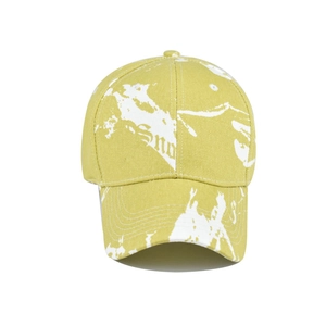 Detailed view of tie-dye baseball cap featuring yellow-green camouflage print and Sno text