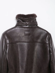 Detail of deep brown faux fur jacket showing the textured leather and plush collar