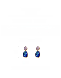 Macro view of vintage geometric drop earrings with purple and blue rhinestones
