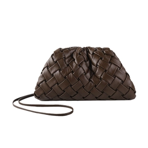 Brown woven leather dumpling bag with drawstring closure and slim crossbody strap