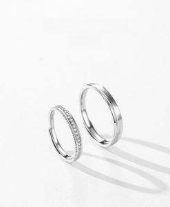 Detailed macro view of S925 sterling silver couple rings with matte finish and zircon inlay