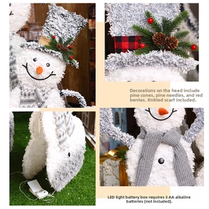 Detail of glowing plush snowman with pine cones, knitted scarf and battery box setup