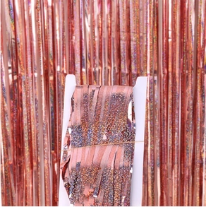 Detailed view of folded rose gold laser tinsel curtain on a cardboard for party decor