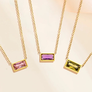 Detailed macro view of rectangular gemstones in pink, purple and green on golden chains