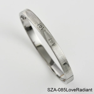 Detailed macro view of silver steel bracelet with LOVE engraving and radiant texture