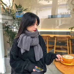 Thick grey knitted winter scarf for men and women featuring warm vertical rib textures