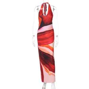 Detail of red abstract print halter dress featuring backless tie design and side slit